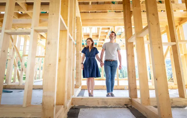 A couple tours their future home during construction