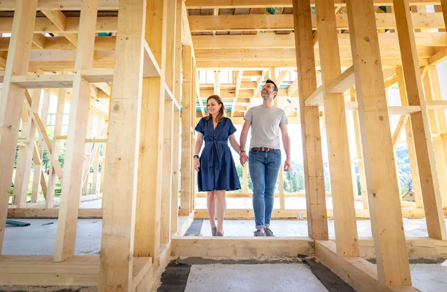 A couple tours their future home during construction