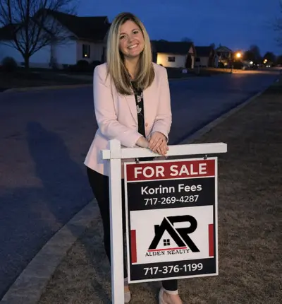 Korinn with Alden Realty sign