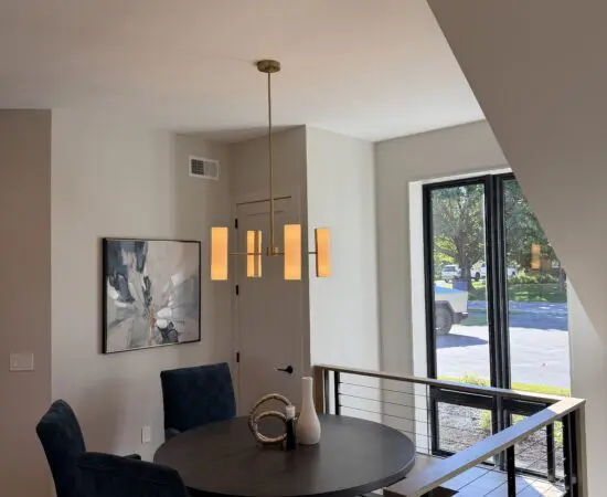 Dinint area next to stairs and large windows